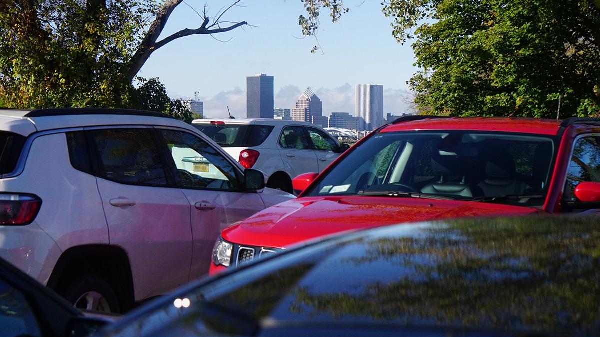 parked cars with Rochester, NY skyline in background.